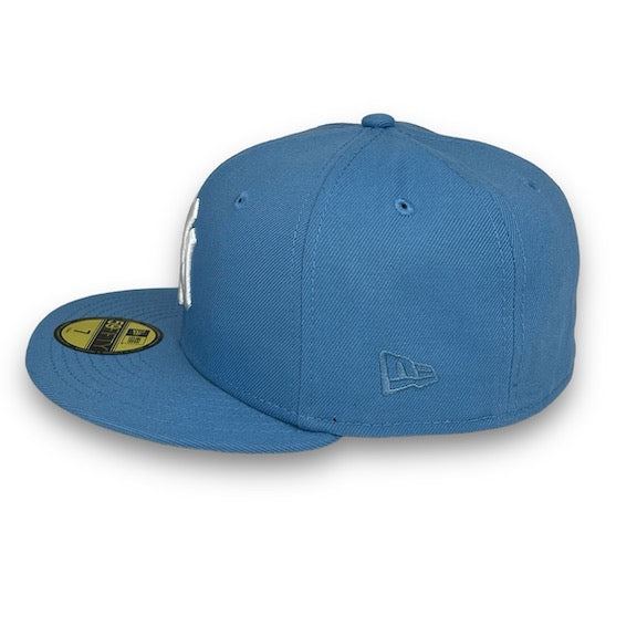 Blue baseball cap with New Era logo on a white background