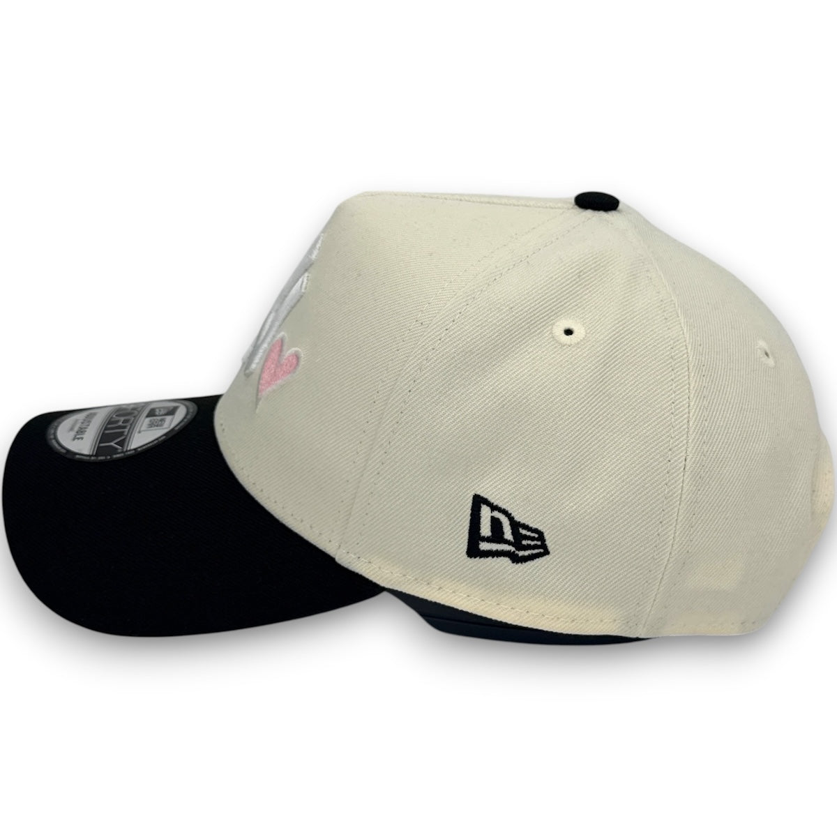 Two baseball caps, one beige and one black, on a white background