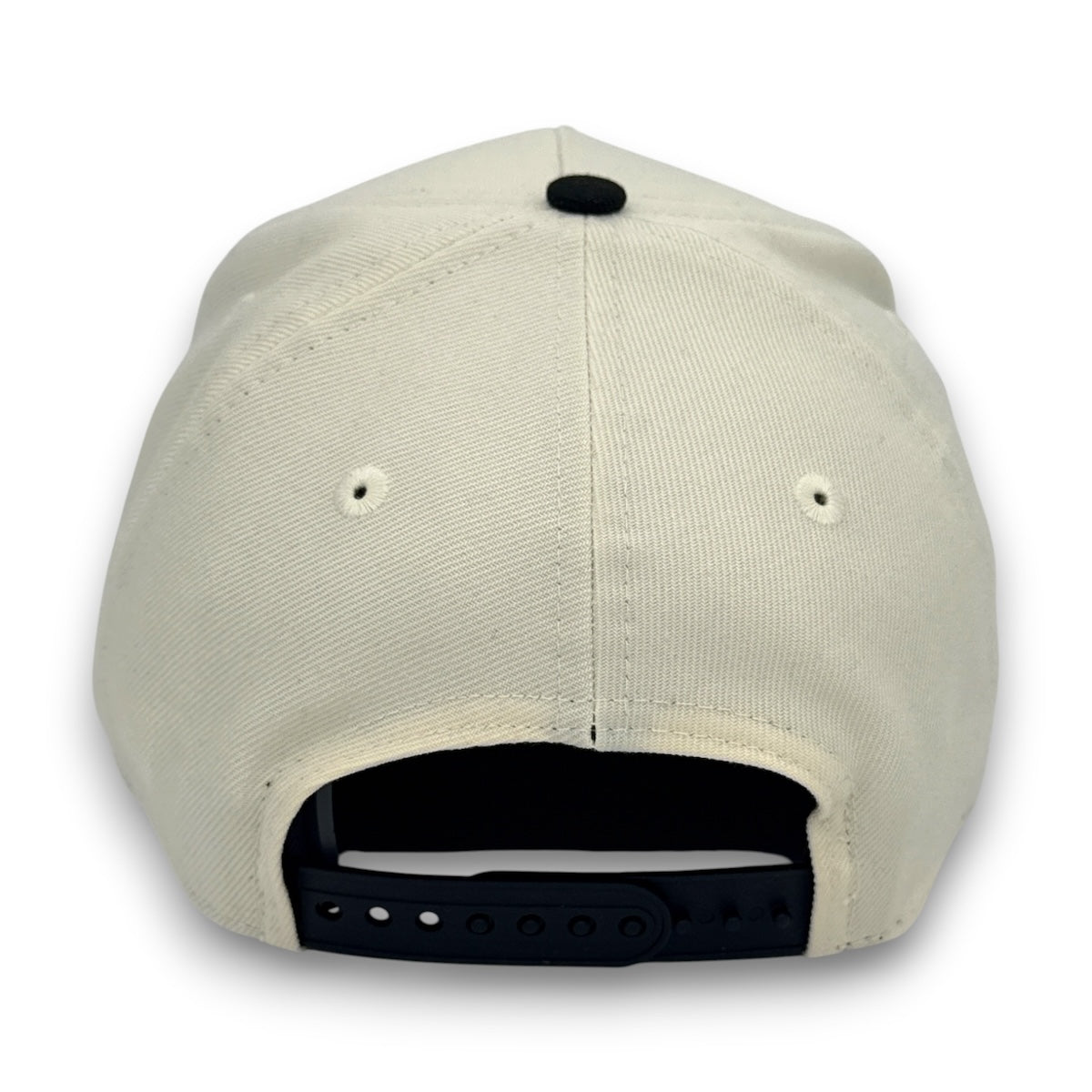 Beige cap with black interior and strap on a white background