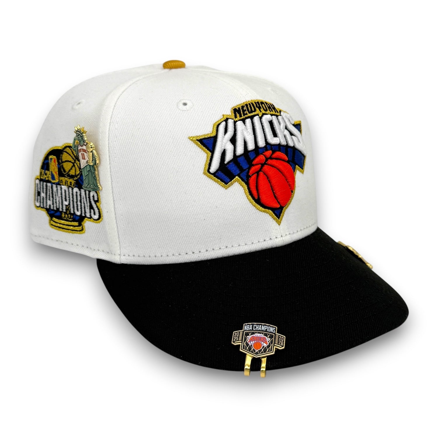 A New York Knicks baseball cap featuring a white crown, black flat brim, and embroidered team logos including a large front Knicks logo and a championship patch on the side.