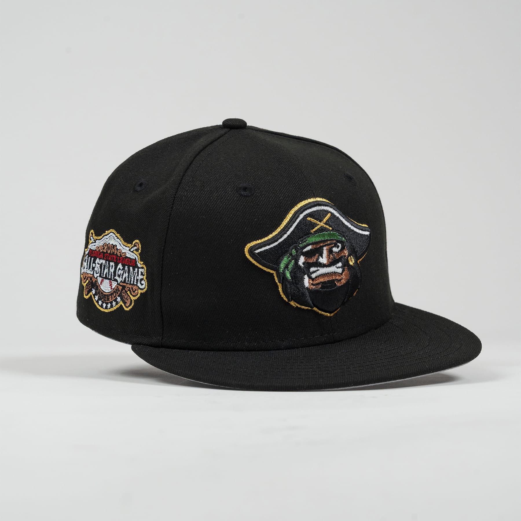 Black cap with embroidered designs on a light gray background- Bradenton Marauders