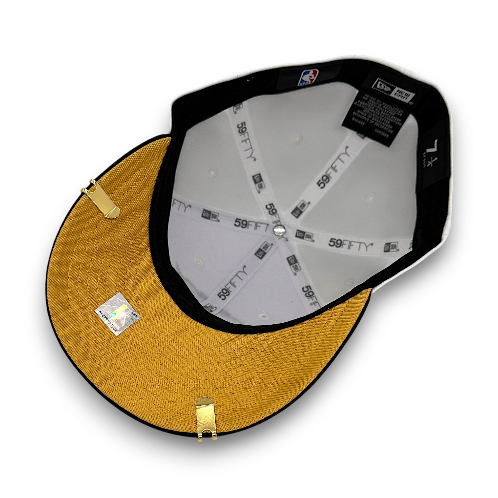 A 59FIFTY fitted baseball cap shown from an overhead angle, featuring a mustard yellow crown, black brim and trim, white interior panels with black printed branding, and gold-tone metal clips.