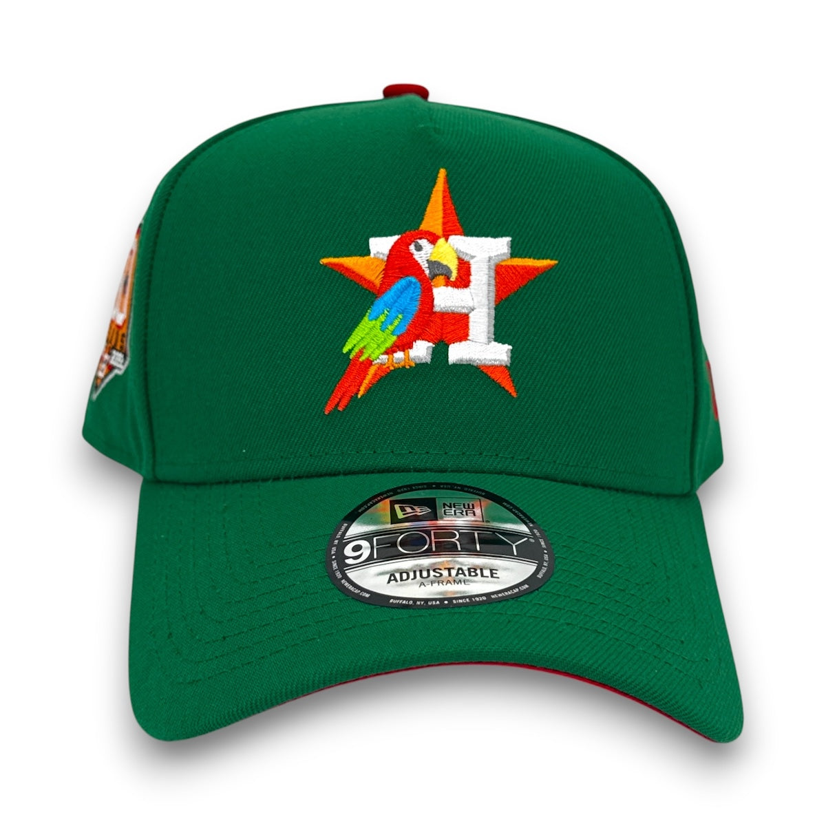 Green cap with colorful parrot design and 'H' logo on a white background