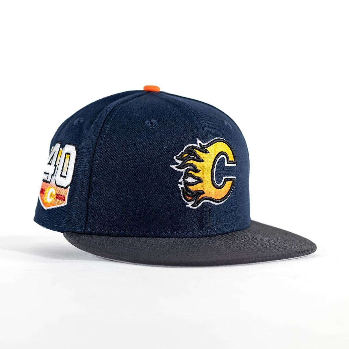 A navy blue flat-brim snapback cap with a yellow and black Calgary Flames logo on the front and a white, orange, and yellow number 40 patch on the side, set against a plain white background.