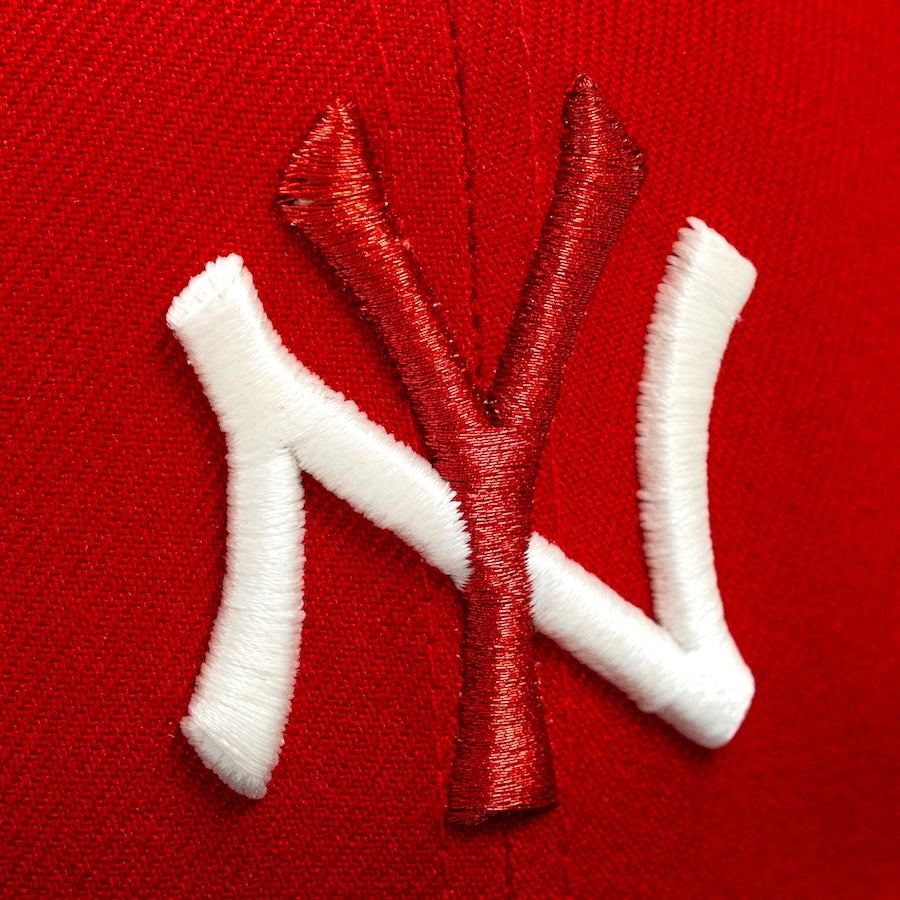 Embroidered 'NY' logo on a red background