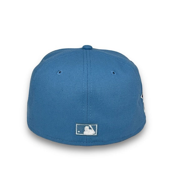 Blue baseball cap with a logo on the back against a white background