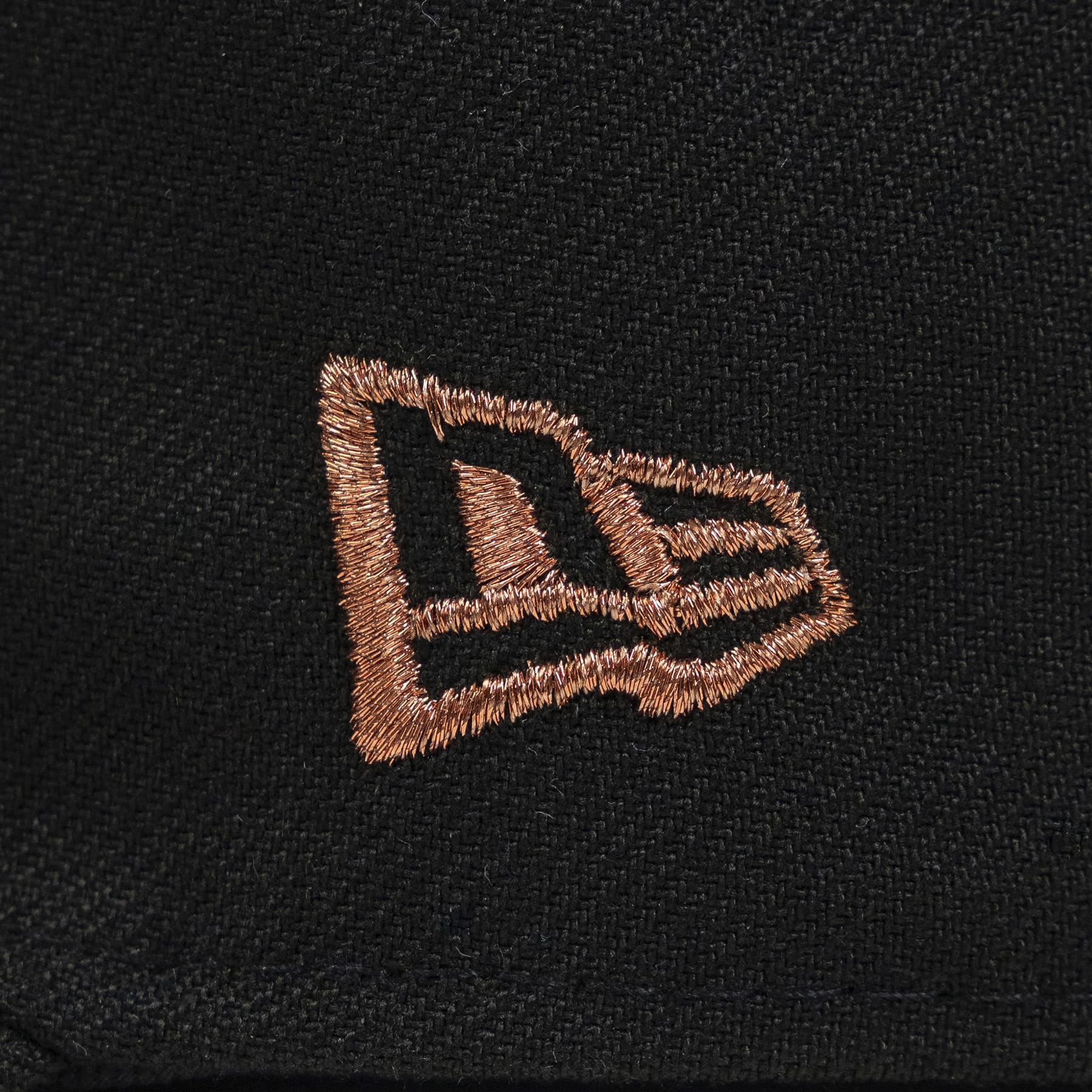 Close-up of a black fabric with an embroidered logo on a dark background. The Pirates Dbacks 98 59FIFTY Black New Era Hat