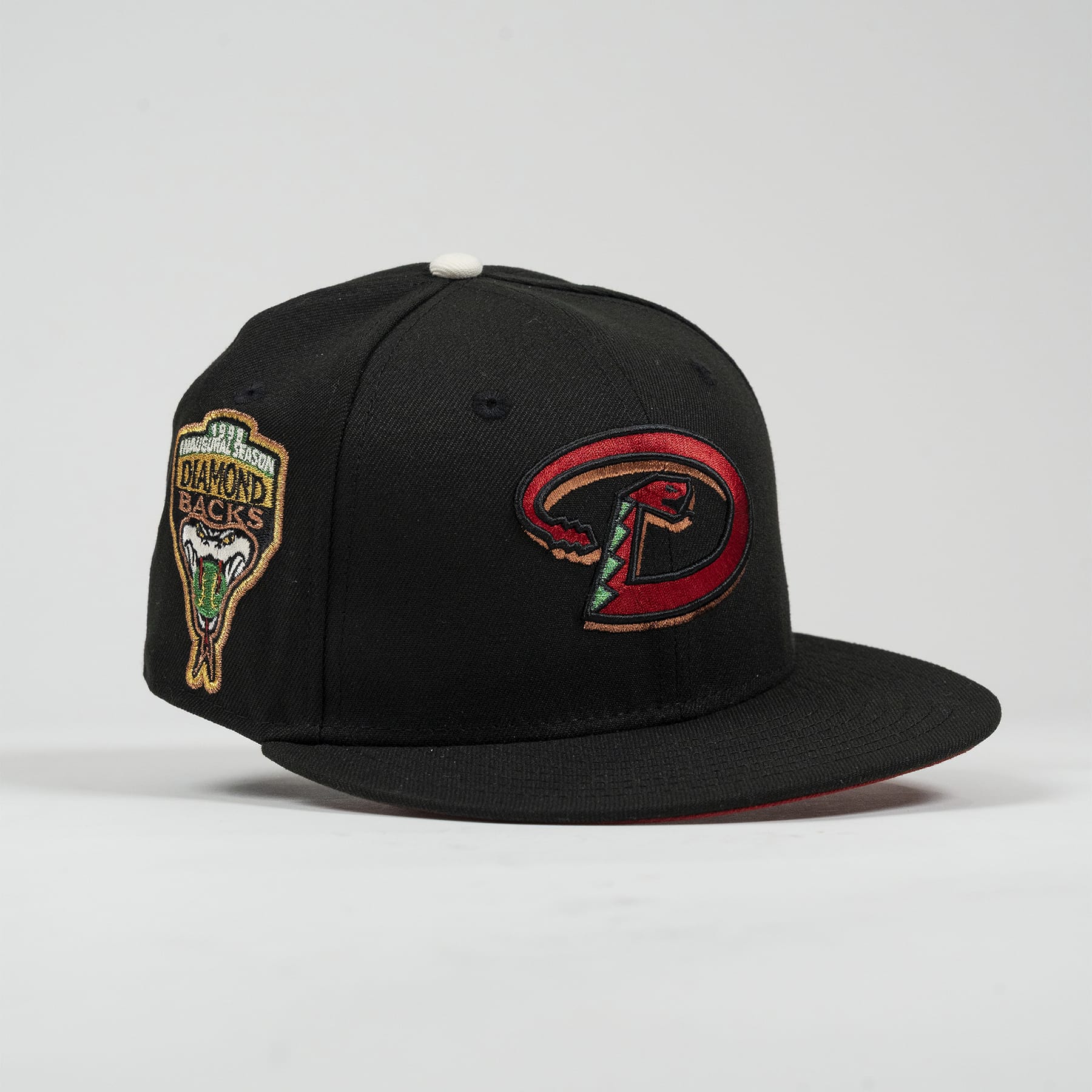 Black baseball cap with logos on a light gray background- The Pirates Dbacks 98 59FIFTY Black New Era Hat