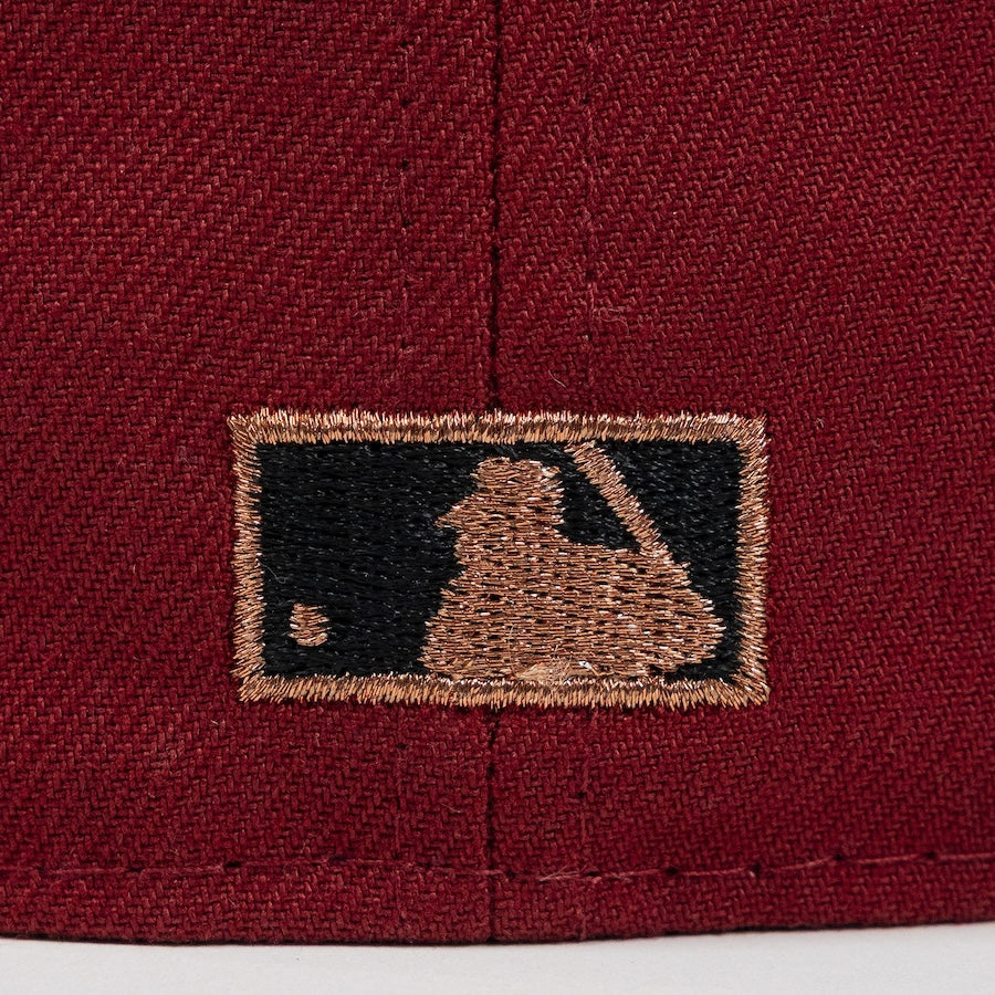 Close-up of a embroidered logo on a maroon fabric background