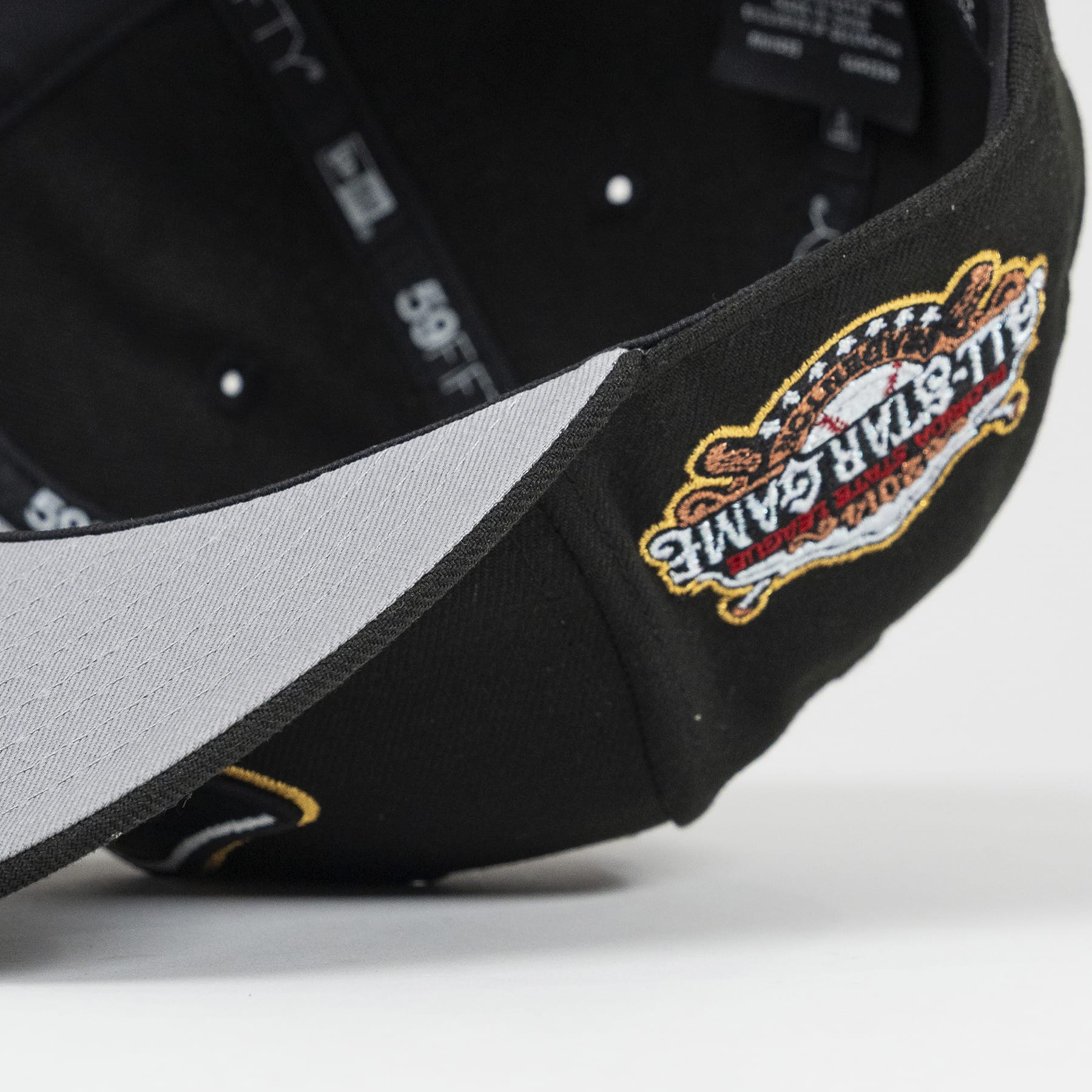 Black cap with a colorful logo on a light gray background. Bradenton Marauders